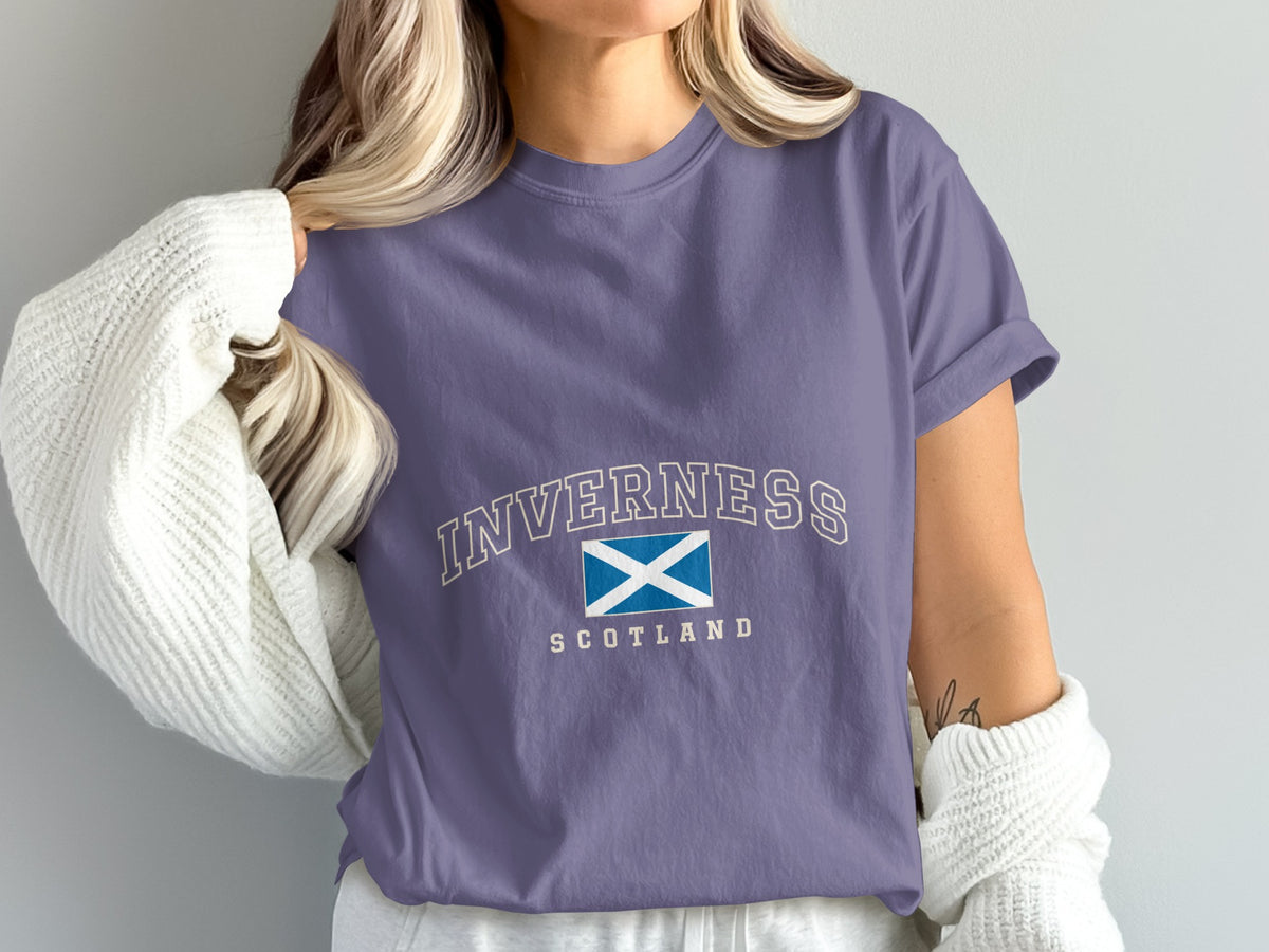 Model wearing the Grape Inverness Scotland Comfort Colors T-shirt with cream collegiate lettering