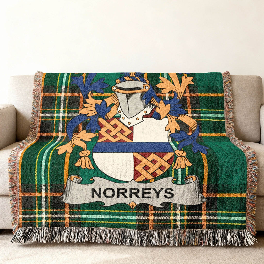 Green tartan blanket with Norreys family crest displayed prominently.