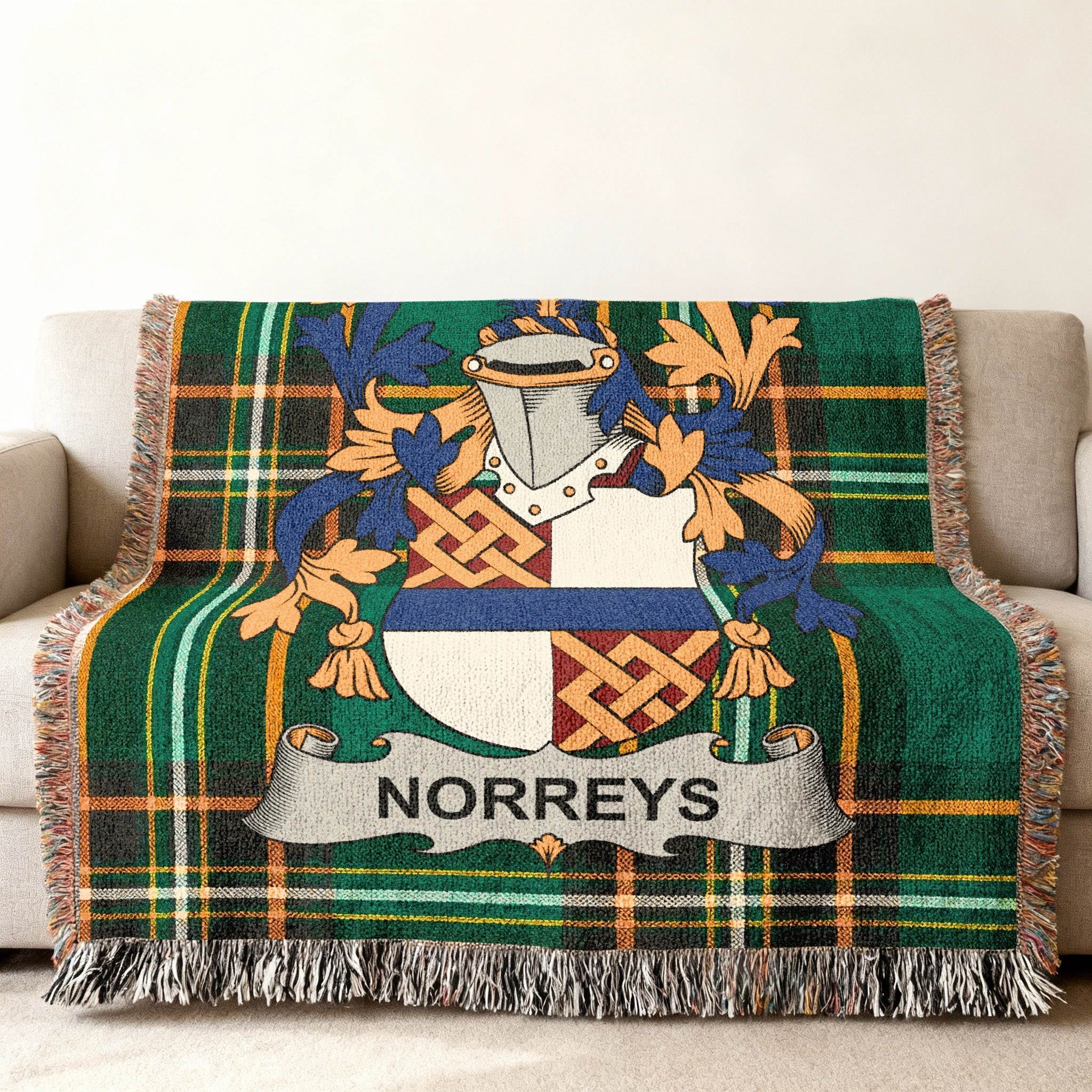Green tartan blanket with Norreys family crest displayed prominently.