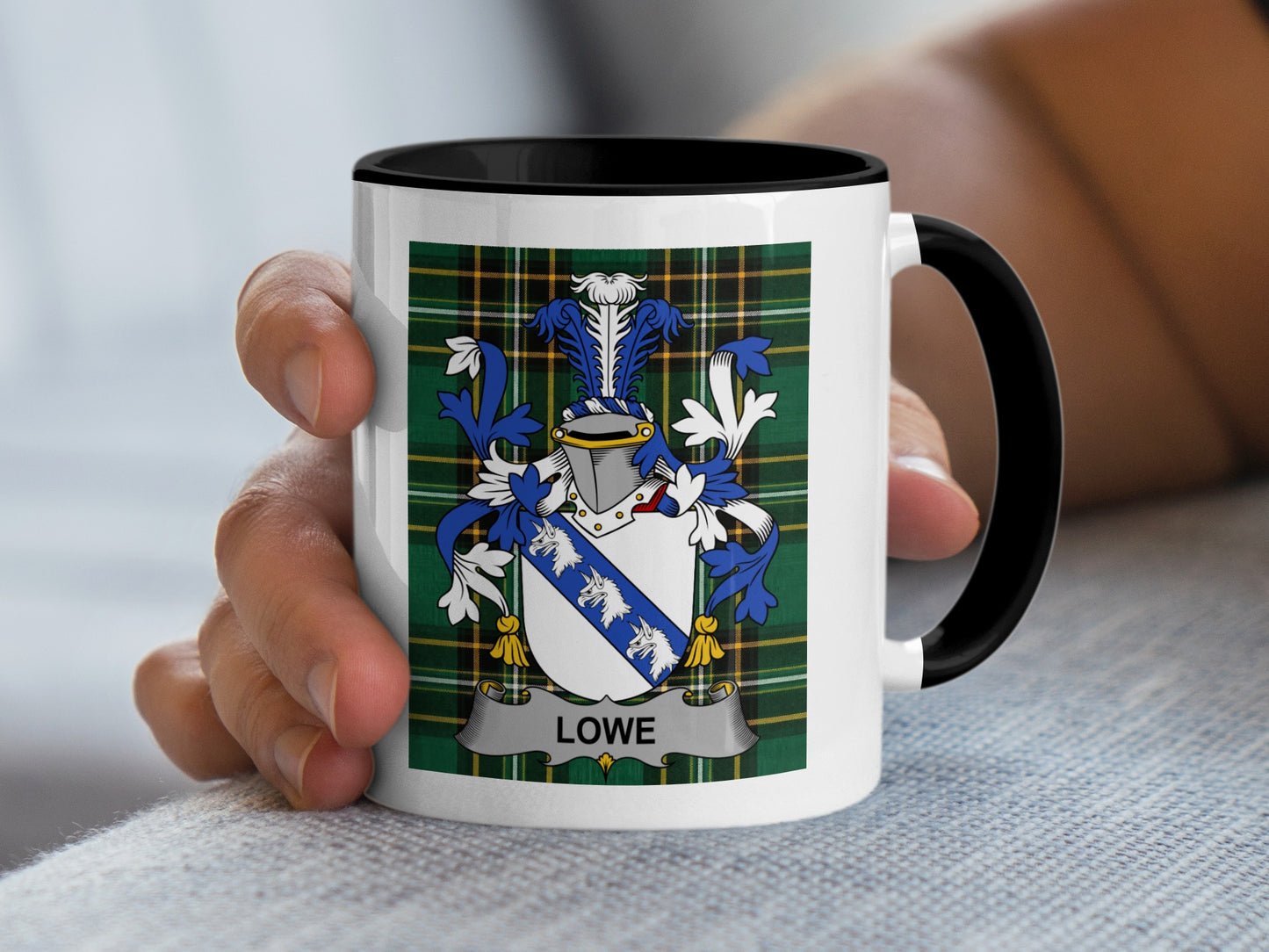 White mug with black rim featuring the Lowe family crest on a tartan background.