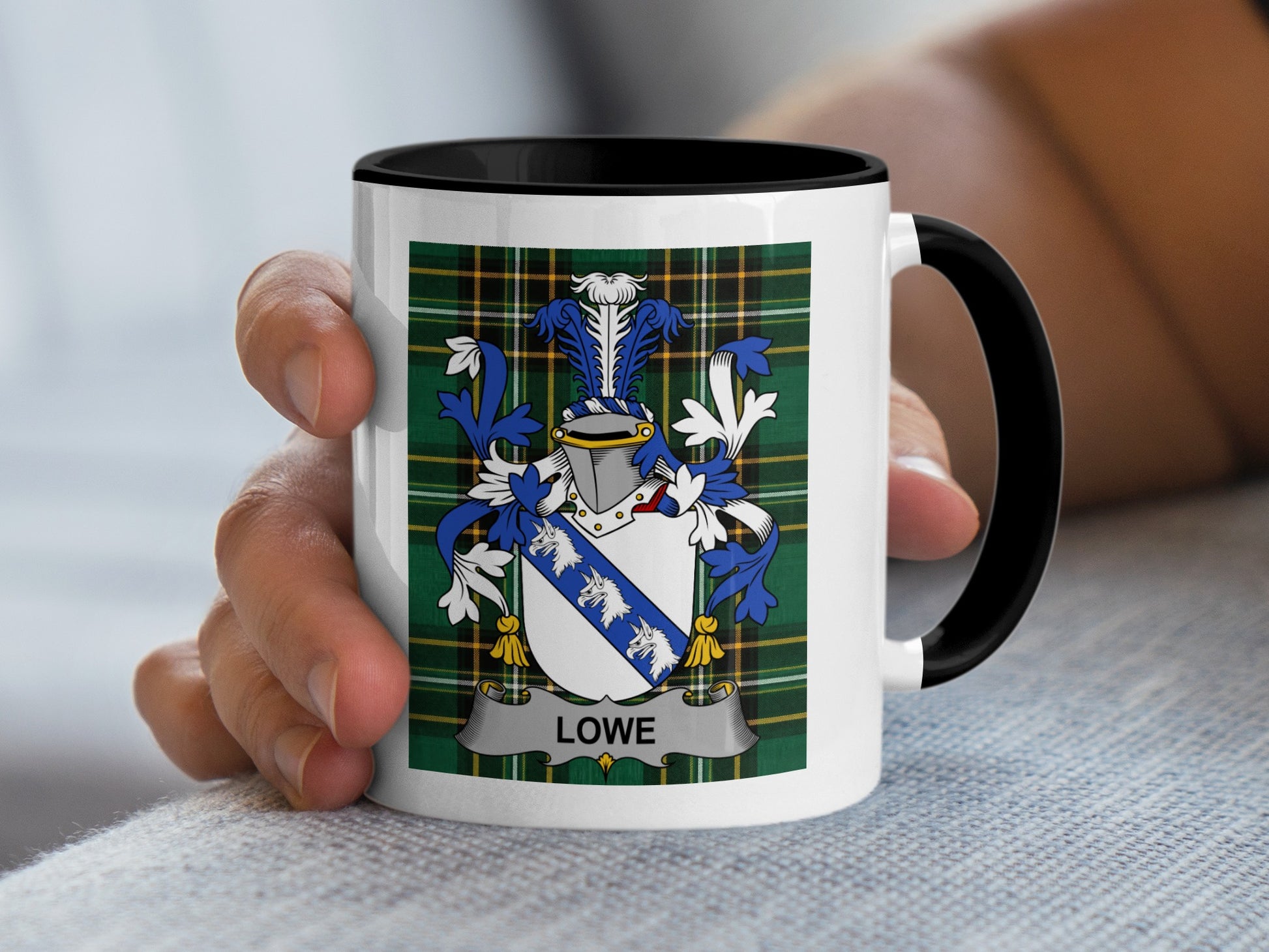 White mug with black rim featuring the Lowe family crest on a tartan background.