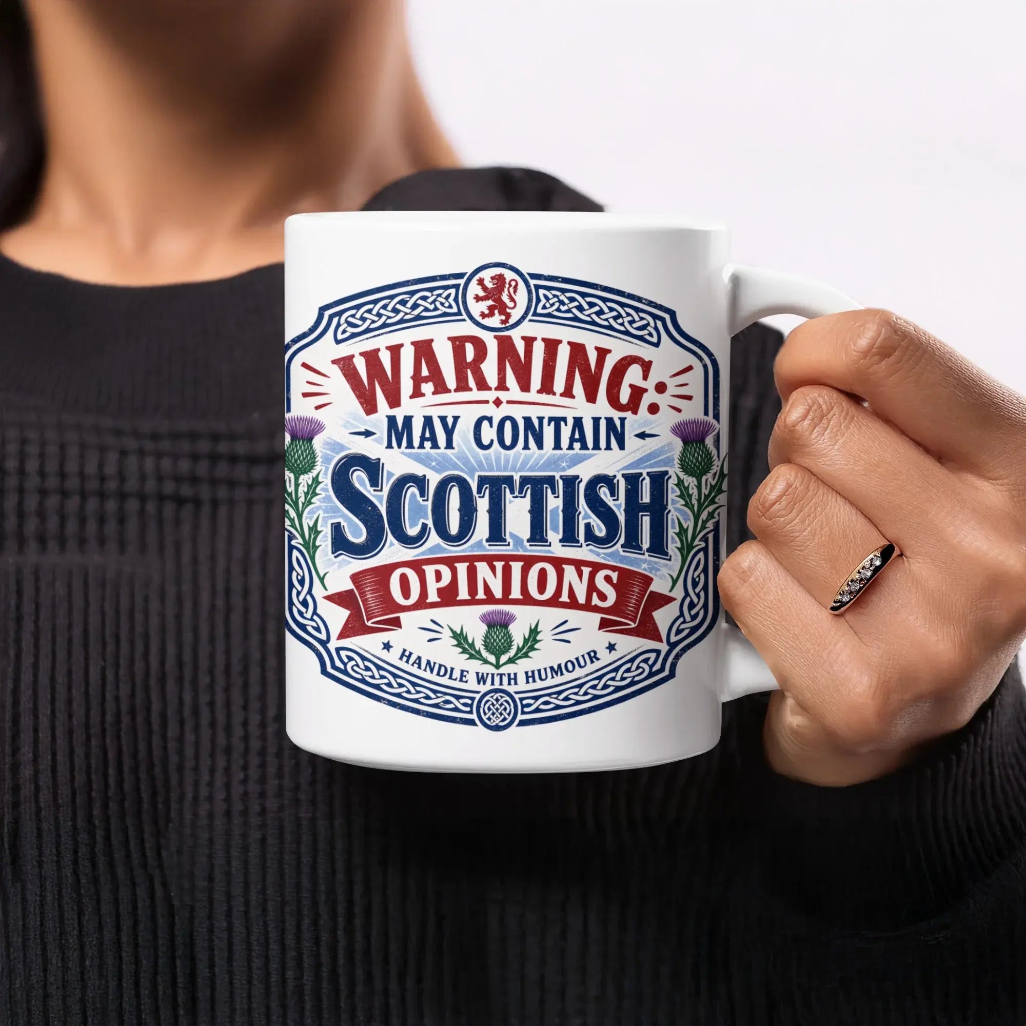 Mug with "Warning: May Contain Scottish Opinions. Handle with Humour." text and thistle design.