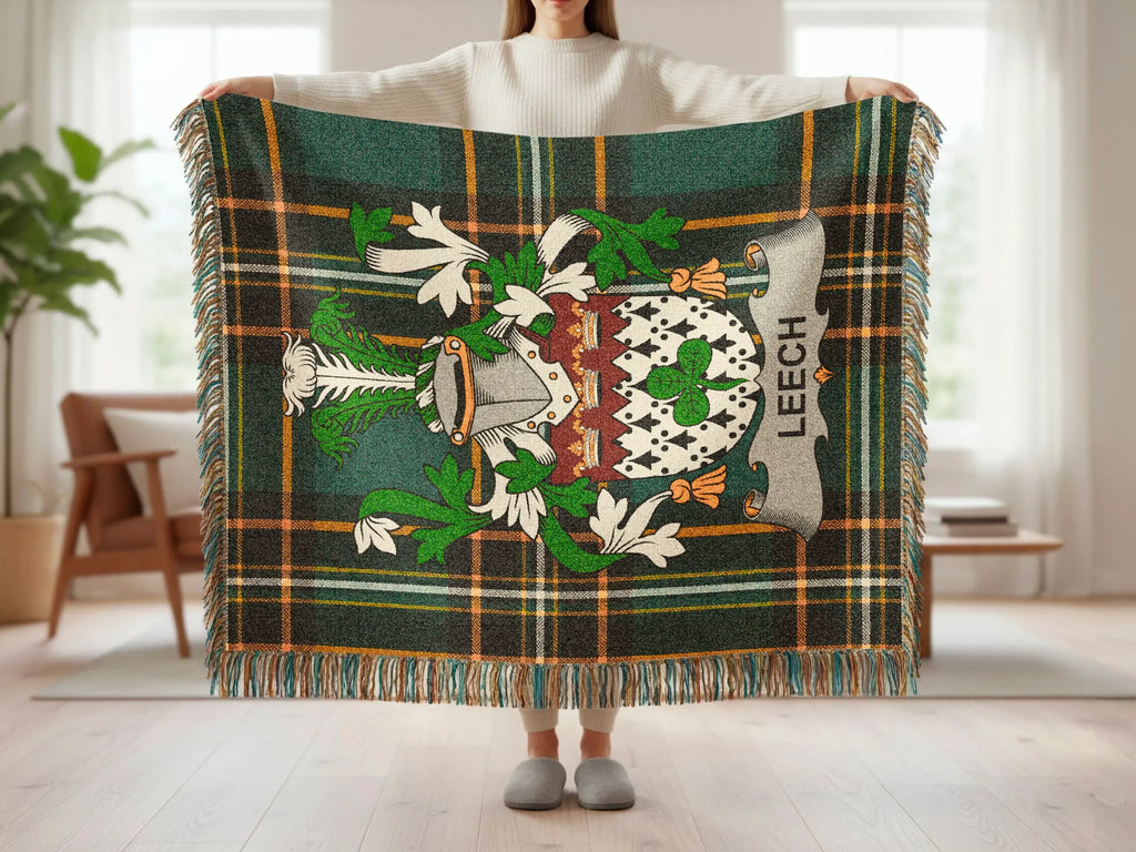 Green, white, and gold plaid blanket with a coat of arms and the text "LEECH".