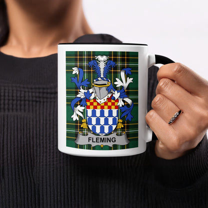Fleming family crest on a white mug held by a person.