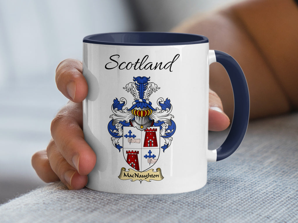 White MacNaughton family emblem mug with navy handle and interior, Scotland text and double-sided artwork