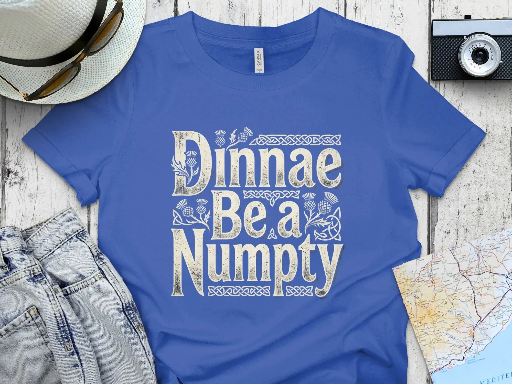Blue t-shirt with "Dinnae Be a Numpty" text and Celtic knot design.