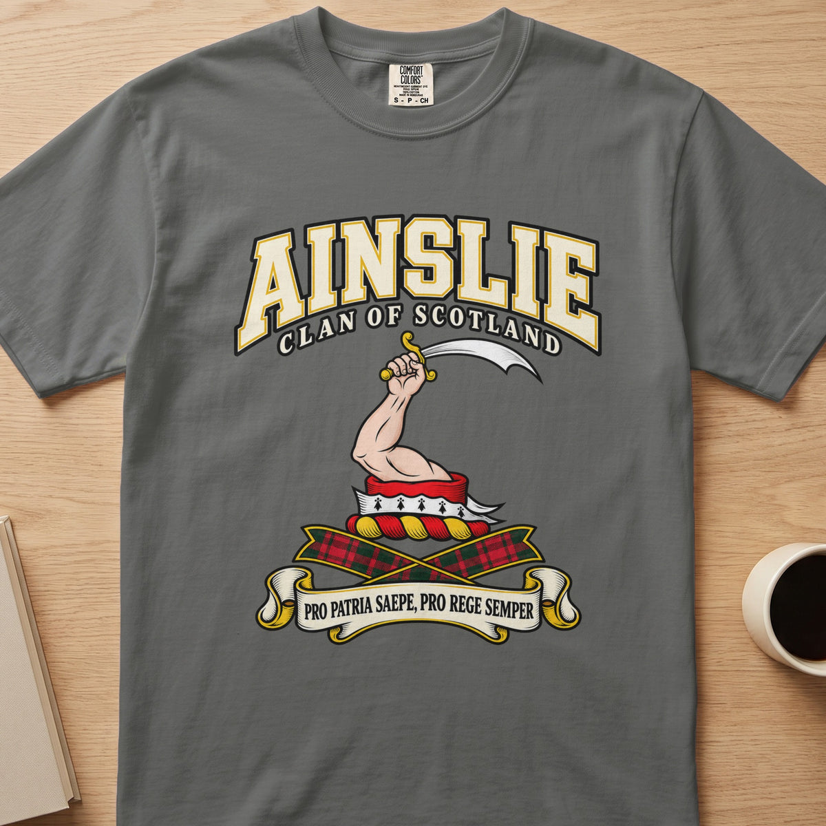 Ainslie raised arm with curved blade graphic on a charcoal gray Comfort Colors T-shirt, front view