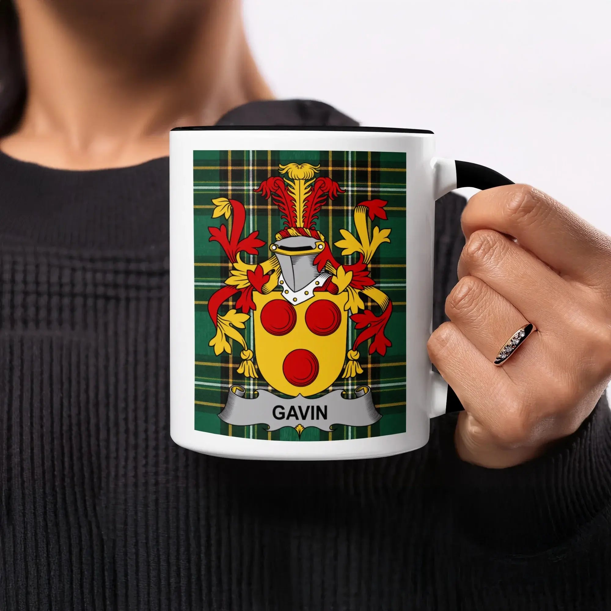 Black mug with black handle featuring a coat of arms with the name GAVIN.