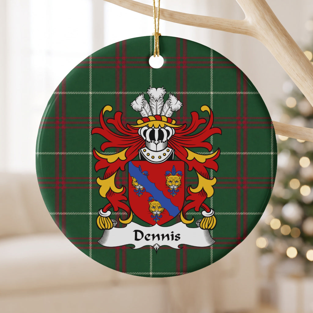 Dennis ornament hanging from a pale wooden branch; three gold faces and a blue diagonal band on a red shield on Welsh national tartan.