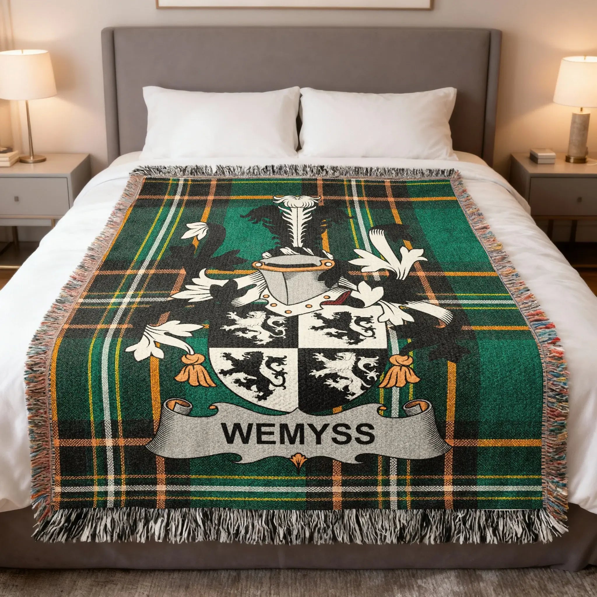 Wemyss family crest on a green plaid throw blanket on a bed.