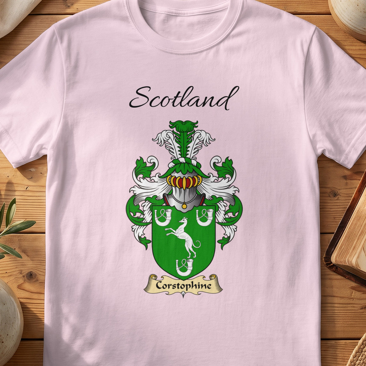 Light Pink Corstorphine Scottish family shield T-shirt featuring a white animal and horseshoes on green