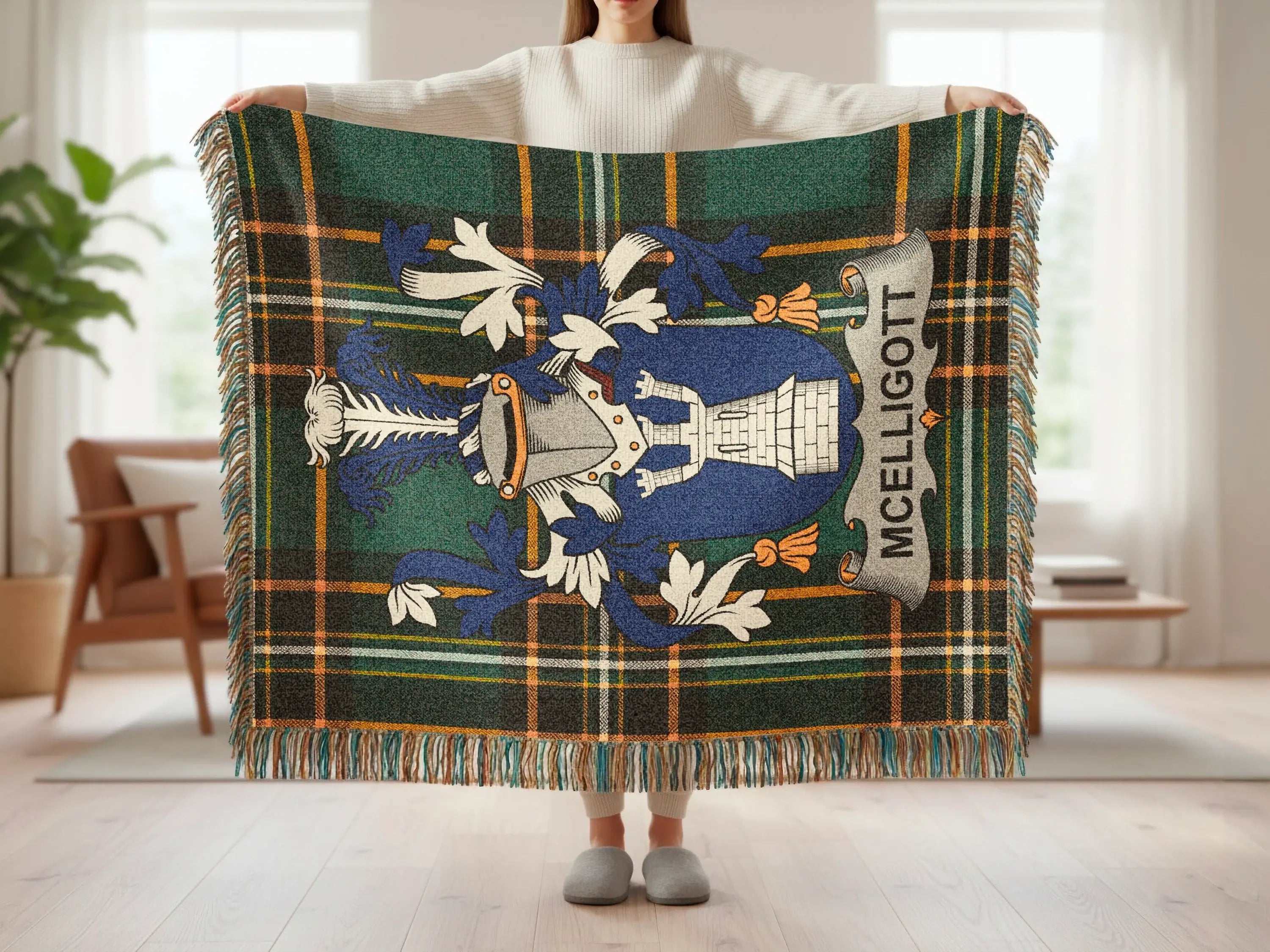 McELLIGOTT tartan blanket with crest, held by a person.
