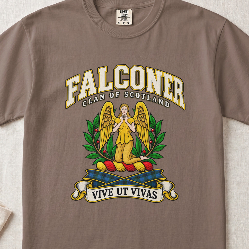 Falconer Scottish clan T-shirt in Espresso, front view with a kneeling gold-winged figure surrounded by green branches and motto banner.