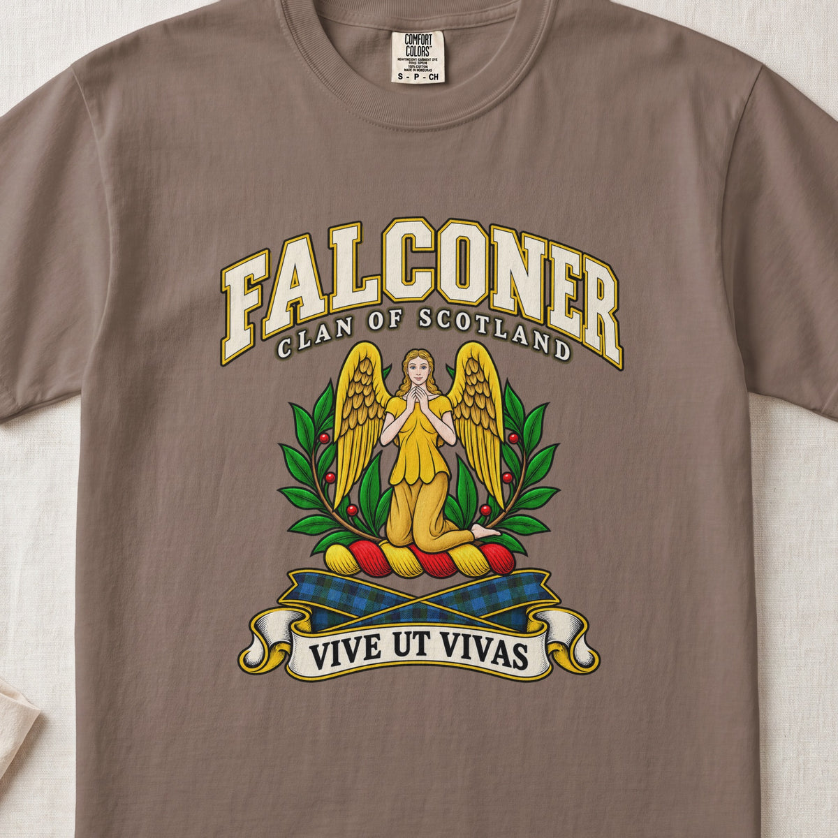 Falconer Scottish clan T-shirt in Espresso, front view with a kneeling gold-winged figure surrounded by green branches and motto banner.