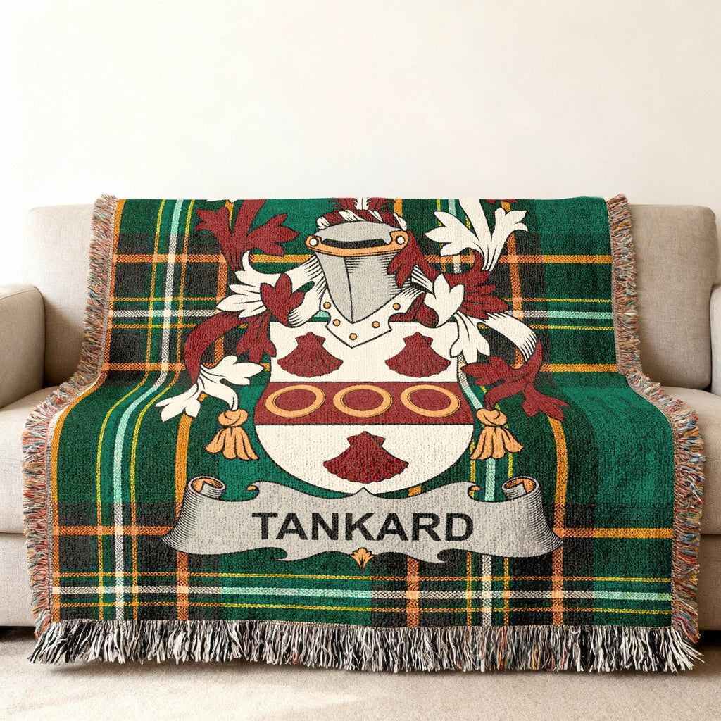 Tartan blanket with Tankard family crest on a couch.