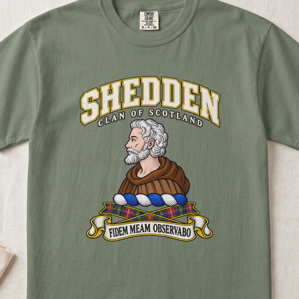 Shedden Scottish clan T-shirt in Moss, front view with a gray-haired, bearded figure in a brown robe and motto design.