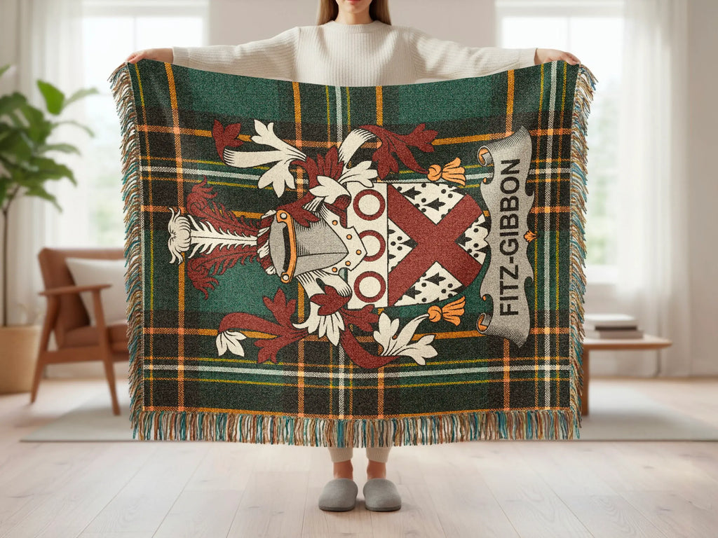 Tartan blanket with Fitz-Gibbon family crest held by a person.