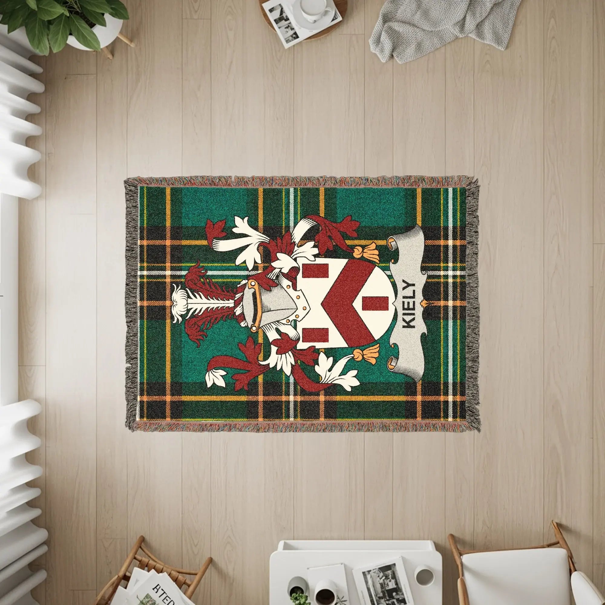 Kiely family crest on green plaid throw blanket with fringe.