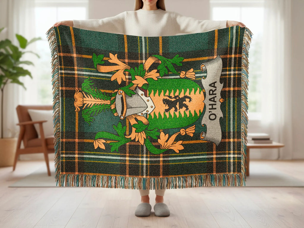 Green tartan blanket with O'Hara crest held by a person.