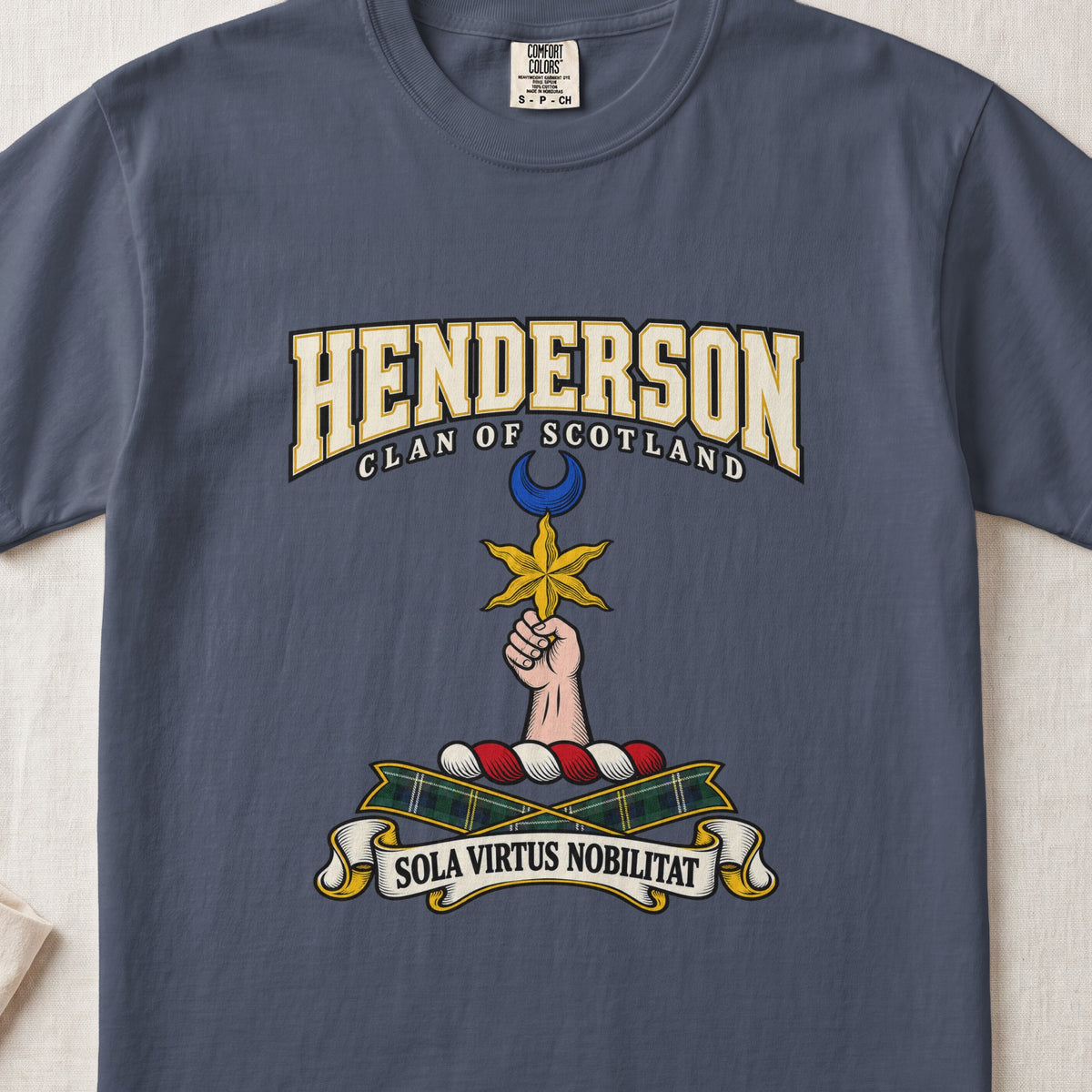 Midnight Henderson Scottish clan T-shirt, front flat lay with varsity lettering, star-and-crescent crest and tartan ribbon.
