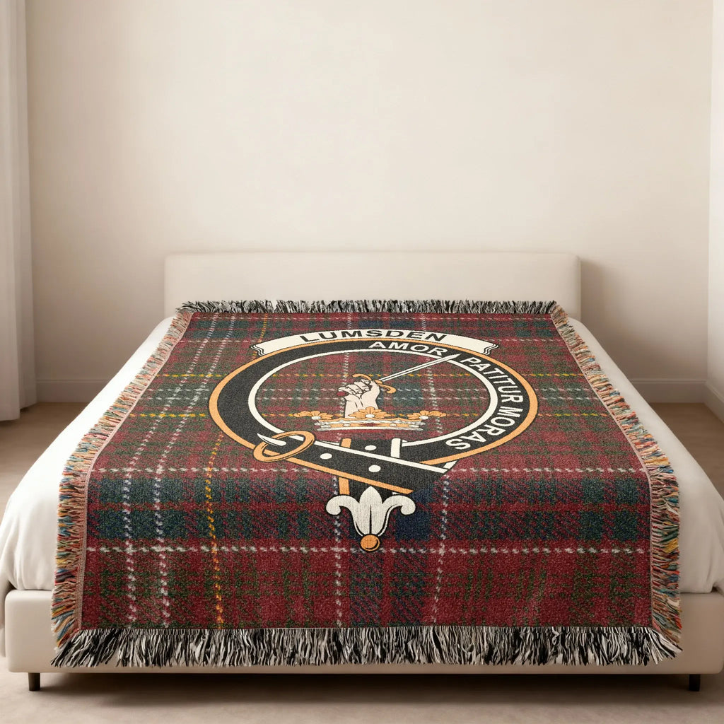 Clan Lumsden tartan woven blanket — lifestyle shot showing Amor Patitur Moras motto and fringe border