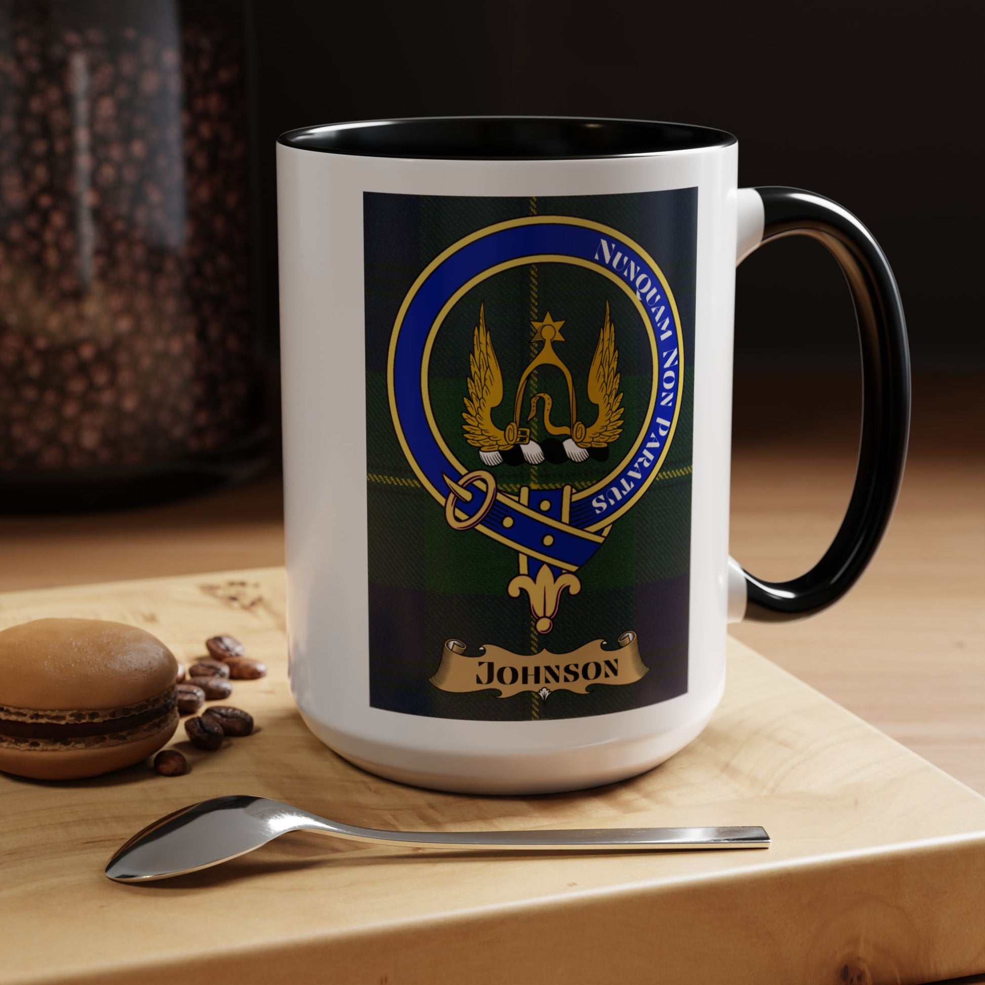 Mug with Johnson tartan and crest against a wooden surface.