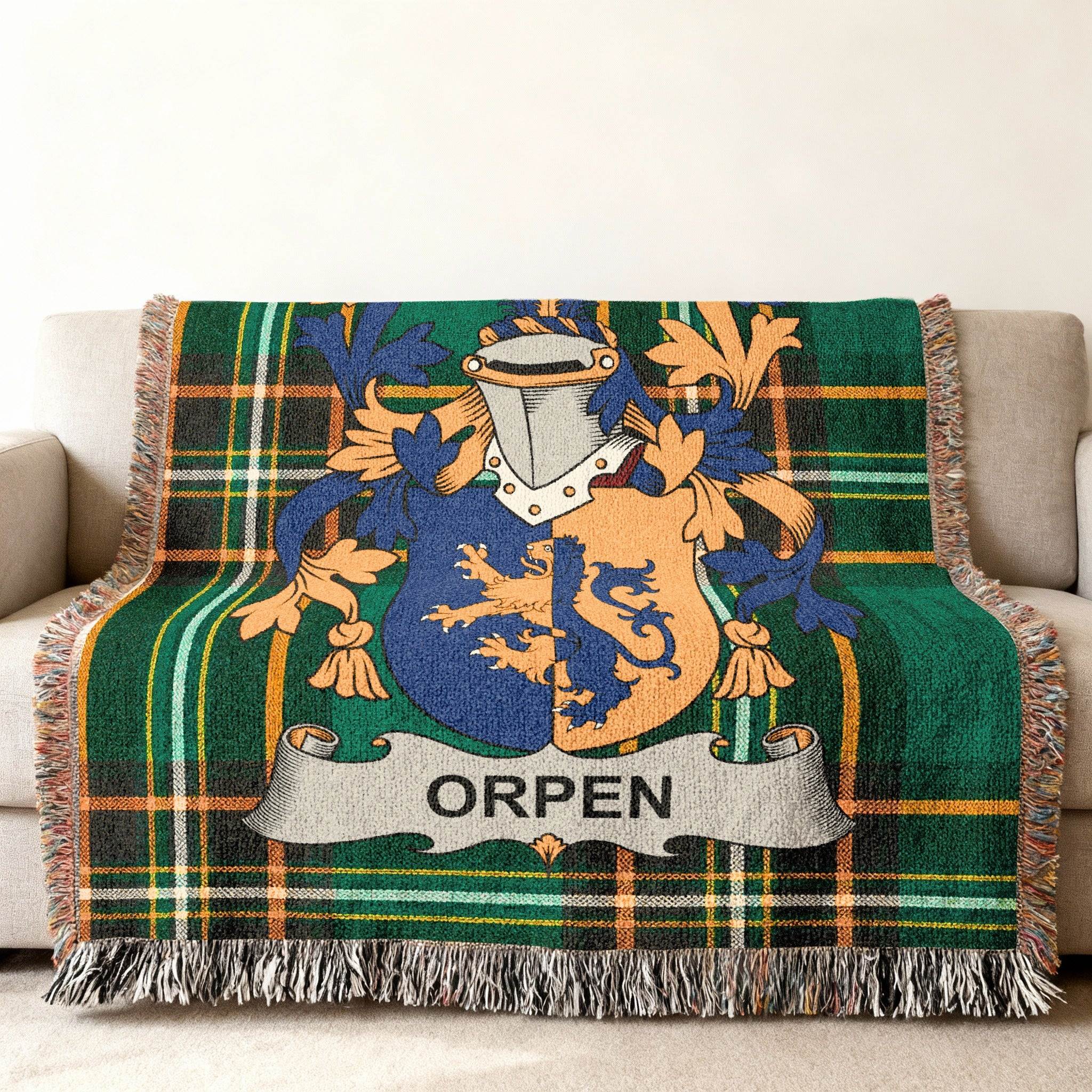 Woven throw blanket with Orpen family crest on green plaid.