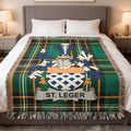Tartan blanket with St. Leger family crest centered on a bed.