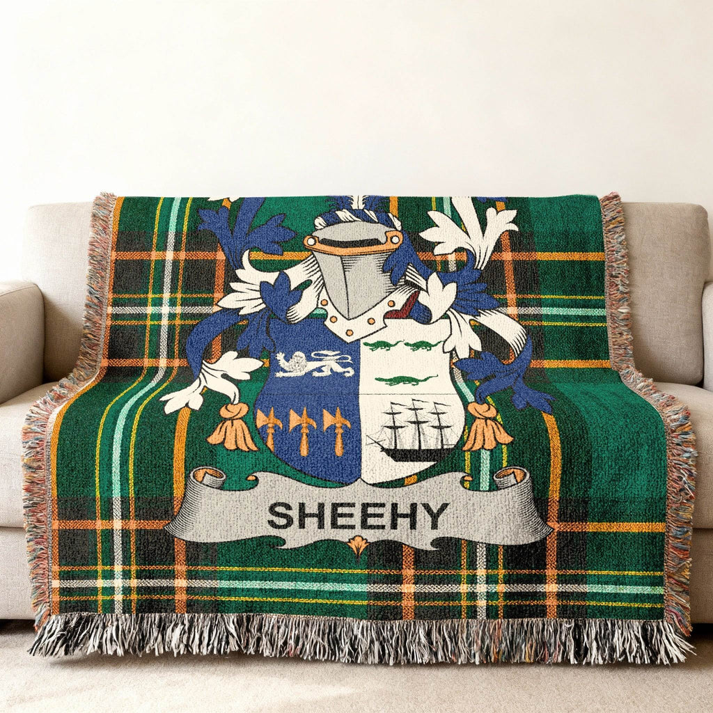 Woven blanket featuring the Sheehy family crest on a green plaid background.