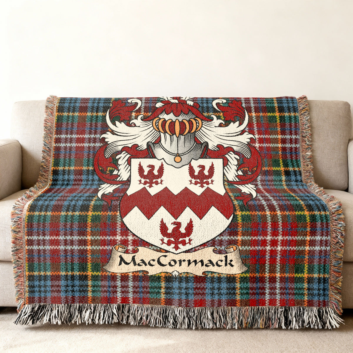MacCormack family crest emblem on a Caledonia tartan woven blanket