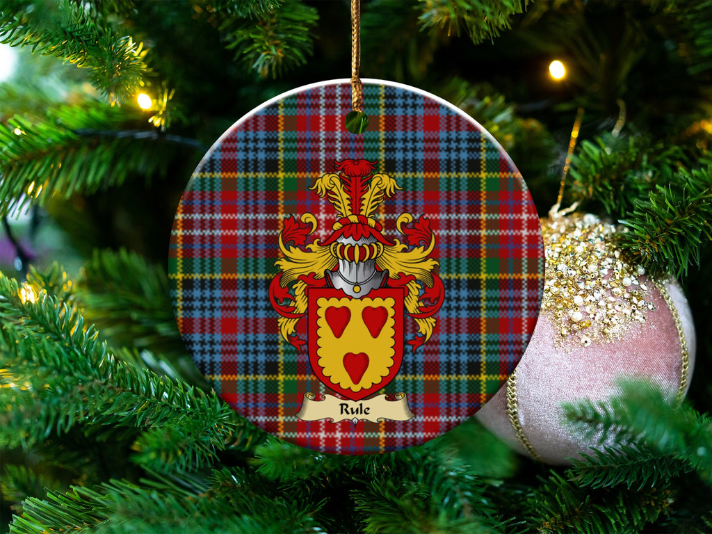 Rule Scottish clan ceramic ornament with family crest on a Caledonia tartan background, hanging on a Christmas tree