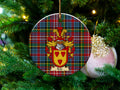 Rule Scottish clan ceramic ornament with family crest on a Caledonia tartan background, hanging on a Christmas tree