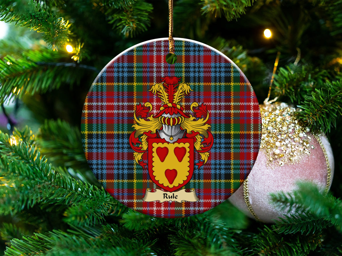 Rule Scottish clan ceramic ornament with family crest on a Caledonia tartan background, hanging on a Christmas tree