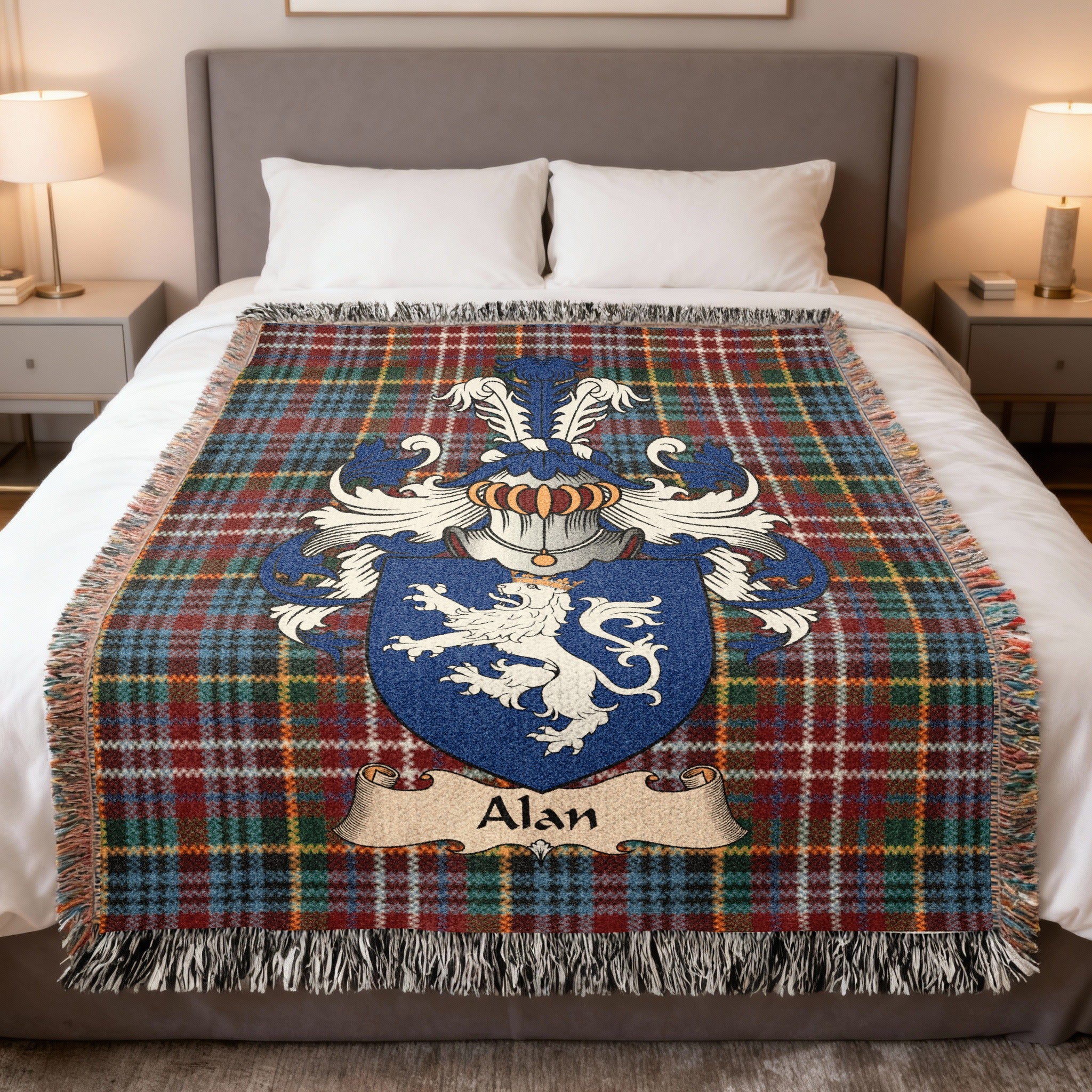 Alan Scottish family crest woven blanket on a Caledonia tartan background, displayed on a bed