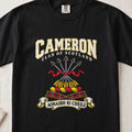 Cameron graphic T-shirt in Black, front flat lay showing varsity lettering and five arrows tied with red ribbon.
