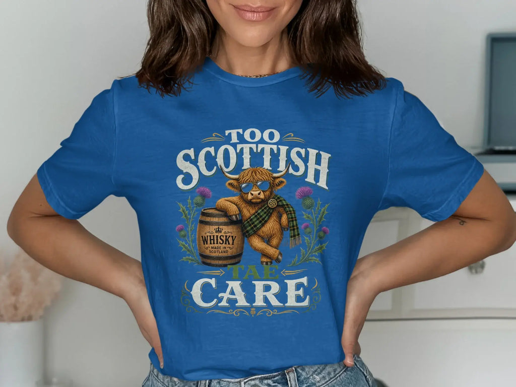 Blue t-shirt with Highland cow graphic, wearing sunglasses and scarf, holding whisky barrel.