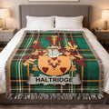 Haldridge family crest on a green plaid woven blanket.