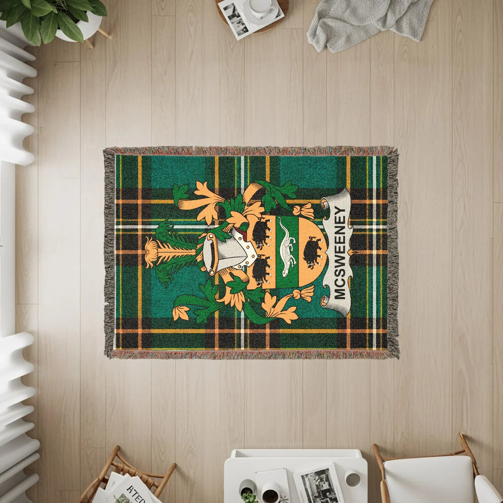 McSweeney tartan blanket with family crest on wooden floor.