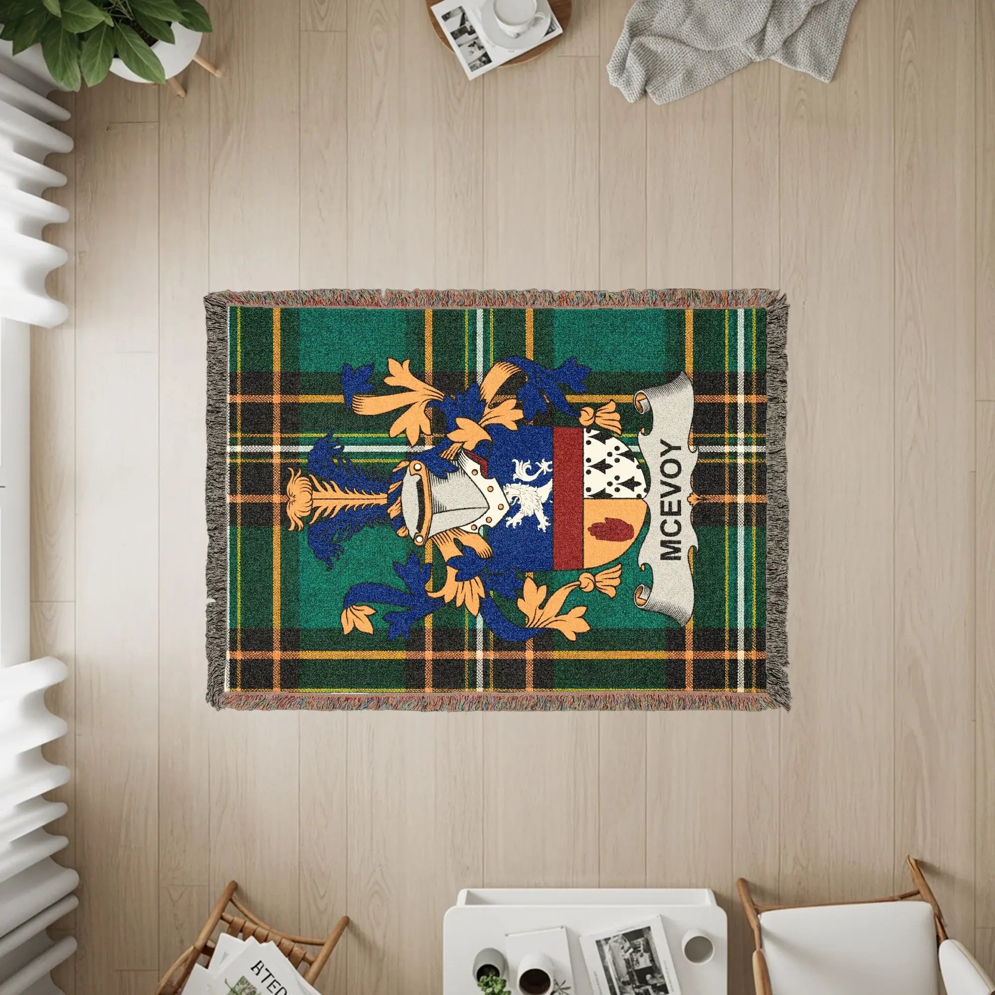 McEvoy family crest on a green plaid woven blanket on a wooden floor.