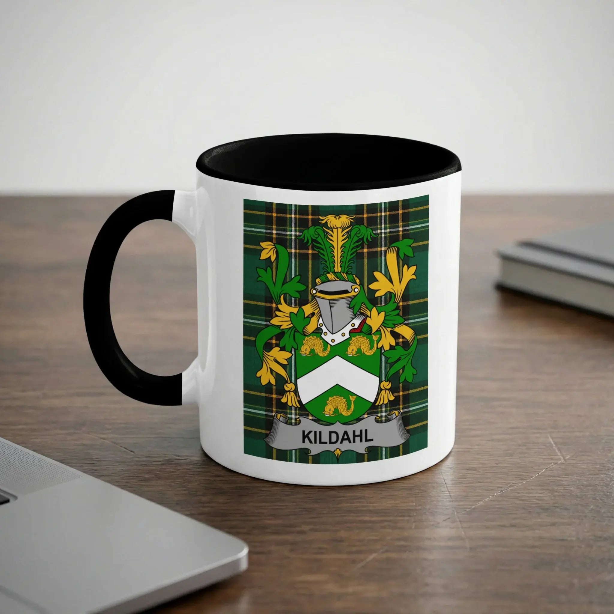 White mug with black rim featuring the Kildahl family crest on a tartan background.