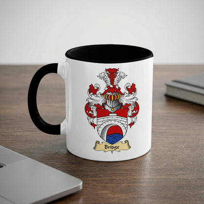 White mug with black rim featuring a coat of arms with "Bridge" text.