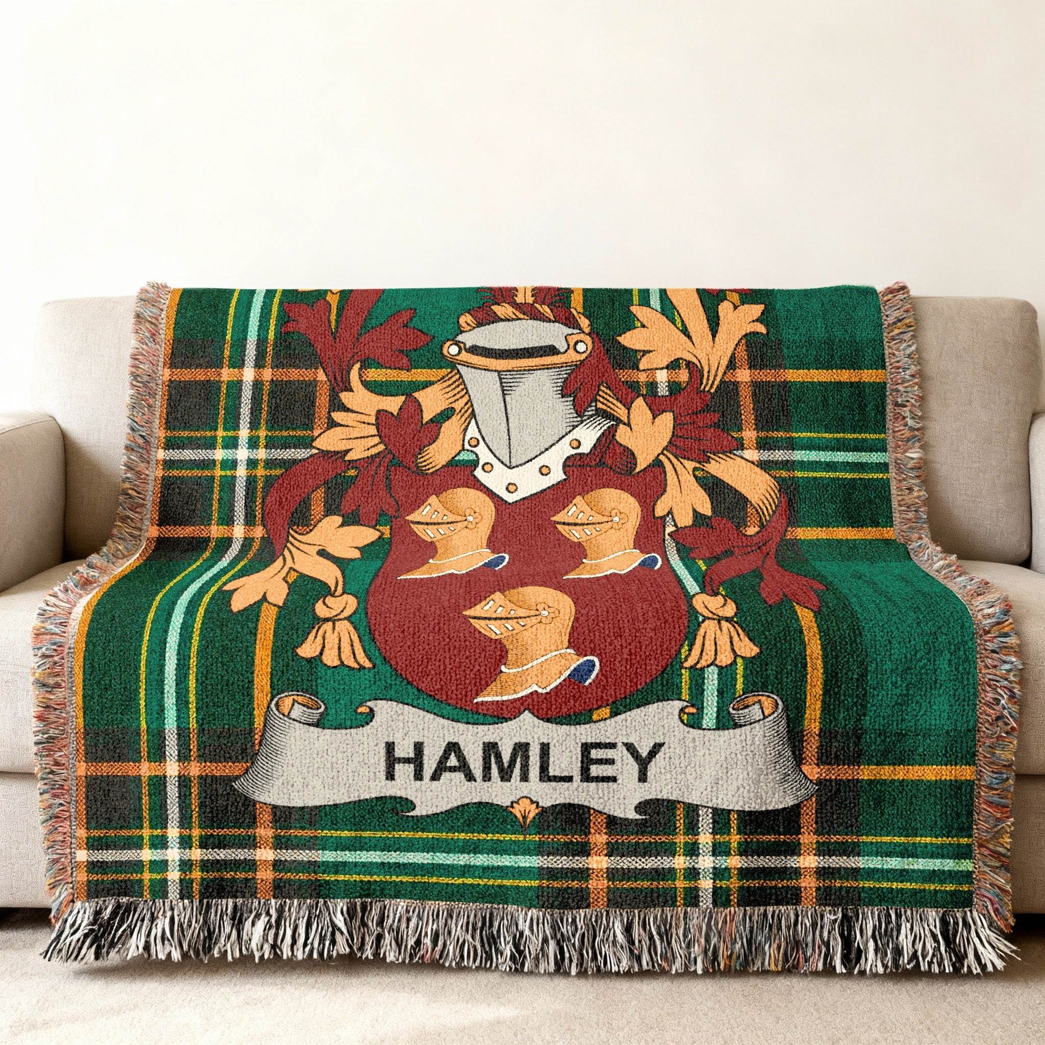 Green plaid throw blanket with Hamley family crest displayed centrally.