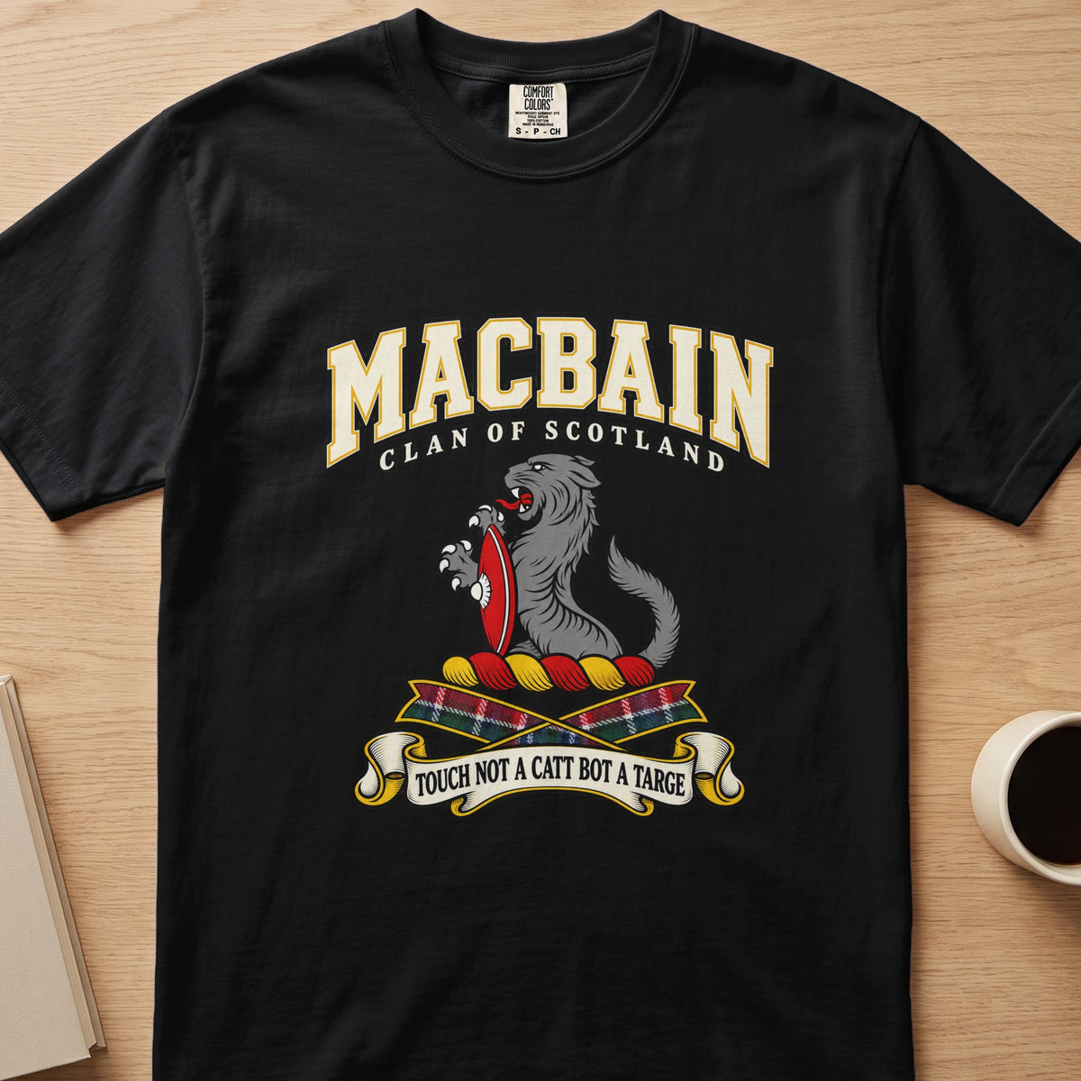 MacBain clan crest with gray cat with red shield on a black Comfort Colors T-shirt, front view