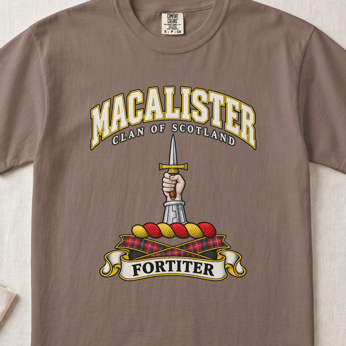 MacAlister Scottish clan T-shirt in Espresso, front view with an armored arm and hand holding an upright dagger and motto design.
