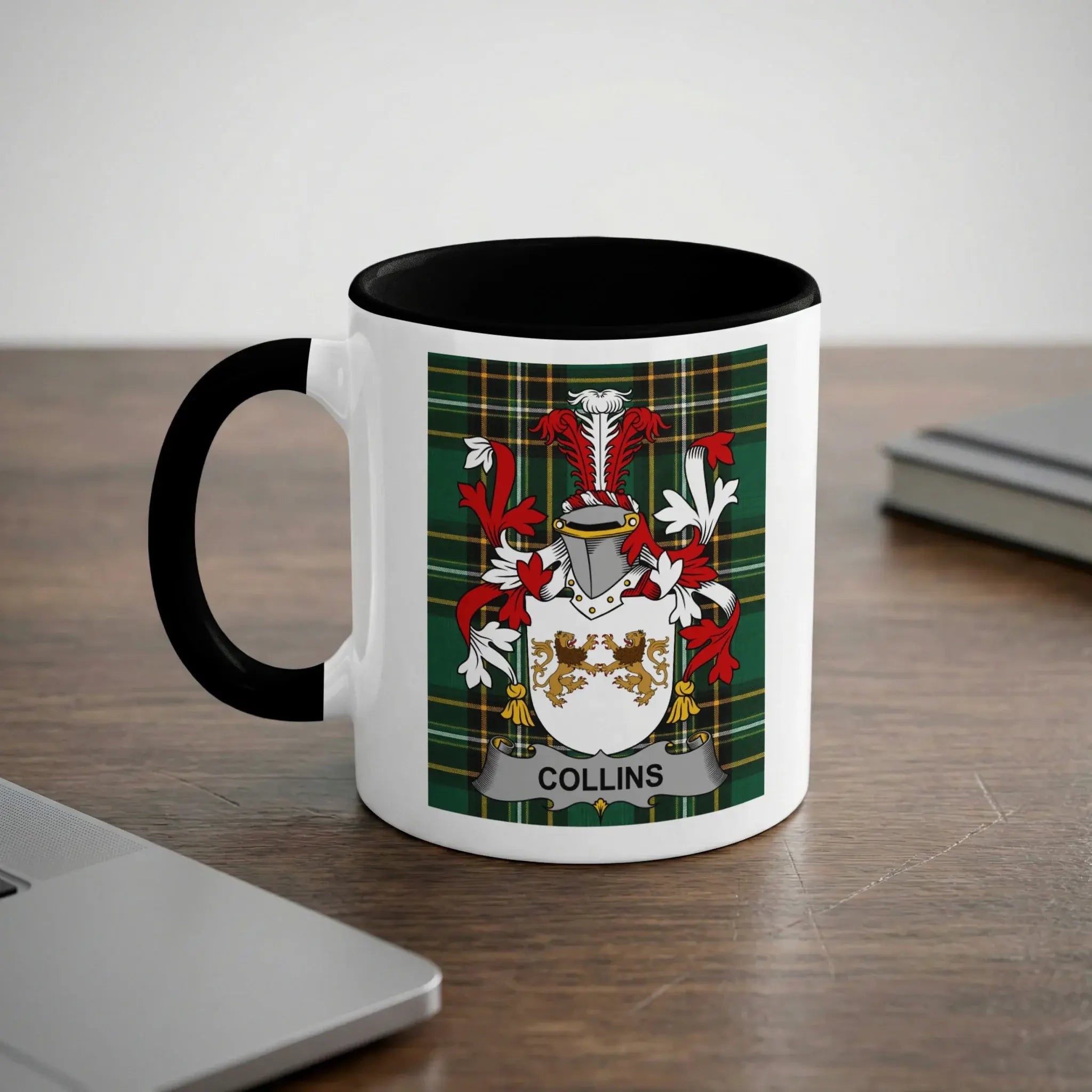 White mug with black handle featuring the Collins family crest on a tartan background.