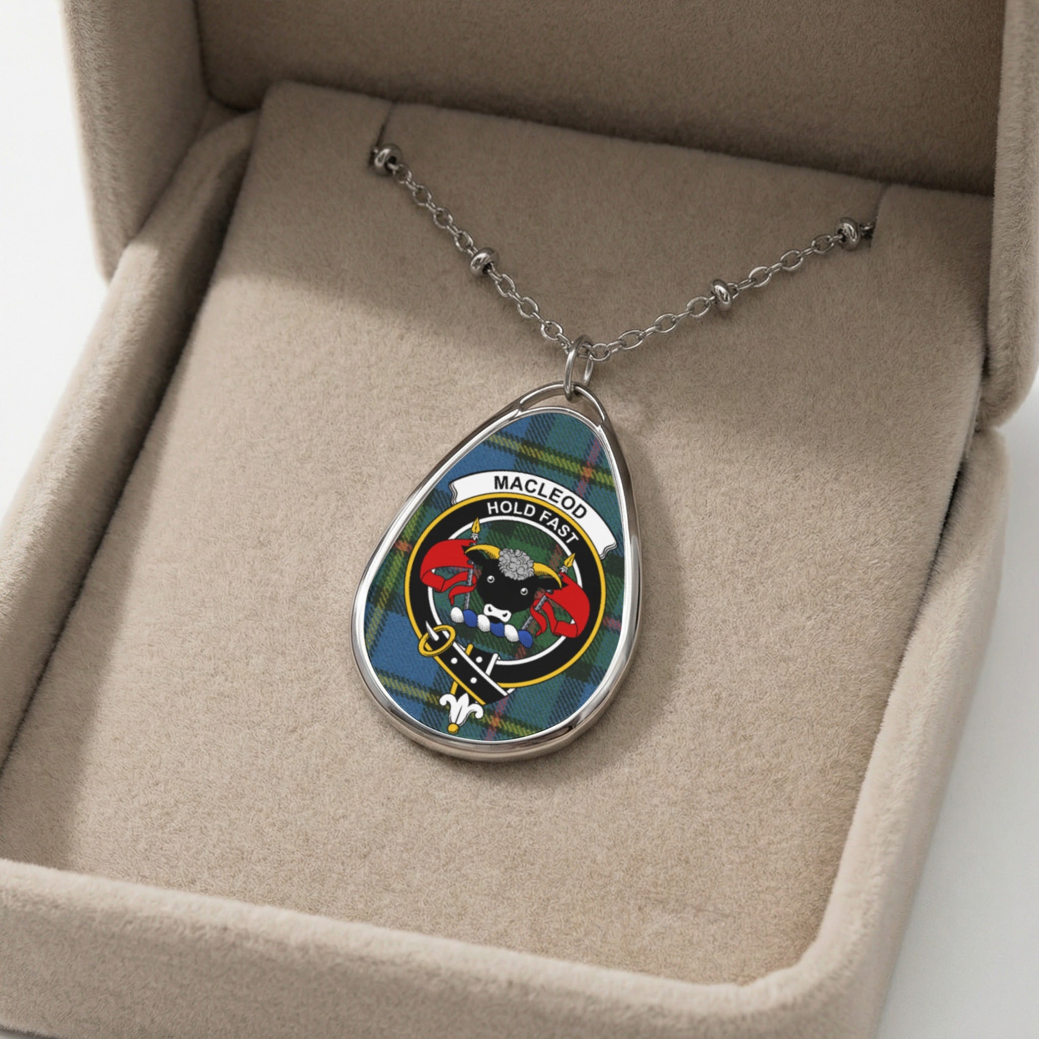 Pendant with MacLeod tartan and crest in a beige jewelry box.