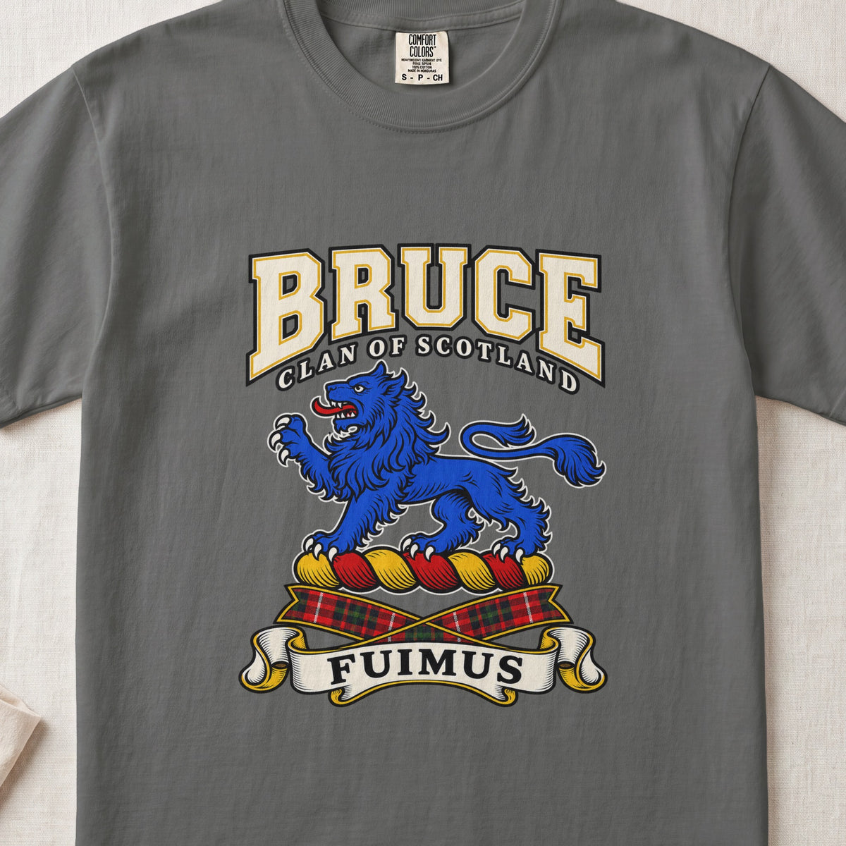 Pepper Bruce Scottish clan T-shirt, front flat lay with varsity lettering, blue lion crest and Fuimus motto.