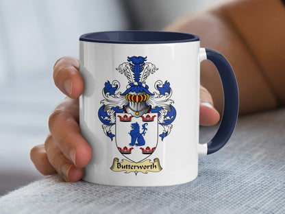 White mug with navy handle displaying a coat of arms with the name Butterworth.