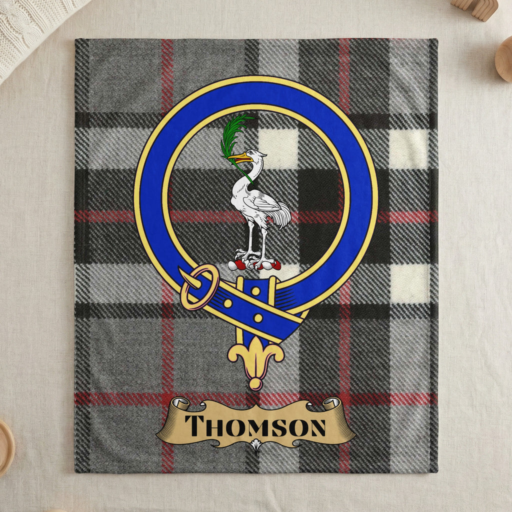 Thomson name scroll and crest on grey tartan throw — draped display