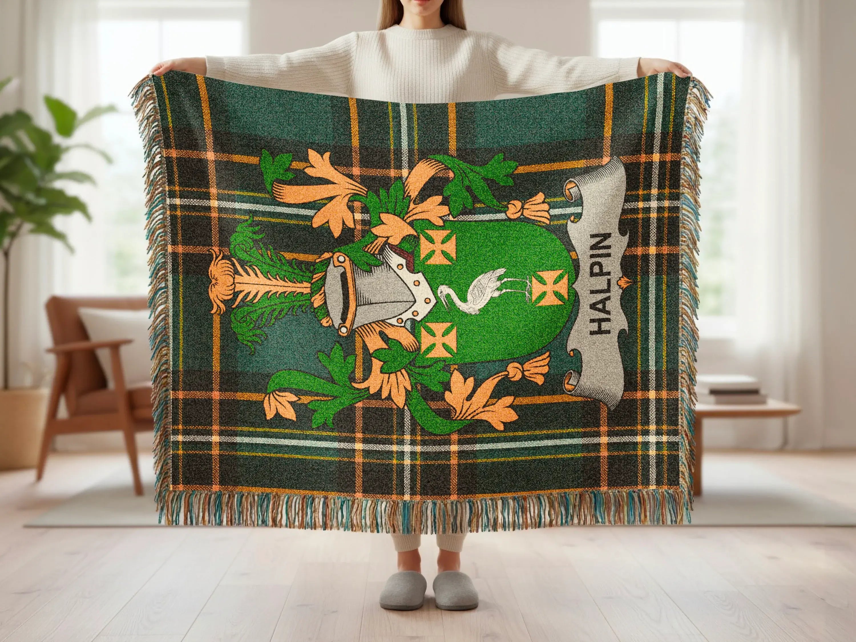 Green tartan blanket with Halpin family crest featuring a bird and helmet.
